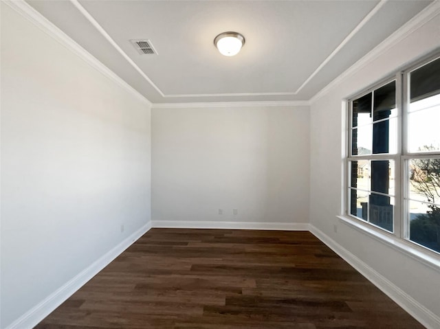 spare room featuring ornamental molding and dark hardwood / wood-style floors