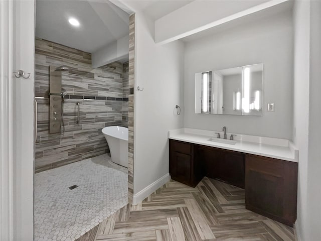 bathroom with parquet flooring, vanity, and plus walk in shower