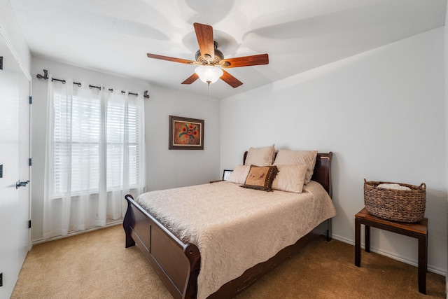 bedroom featuring light carpet and ceiling fan