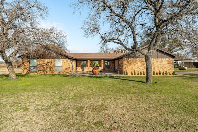 view of front of house with a patio and a front yard