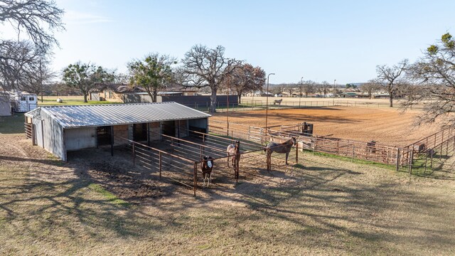 view of home's community with a rural view and an outbuilding