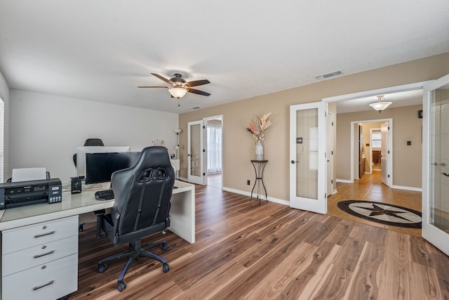 home office featuring ceiling fan, wood-type flooring, and french doors