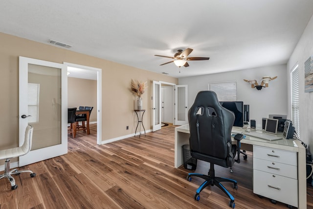 home office featuring french doors, ceiling fan, and hardwood / wood-style floors