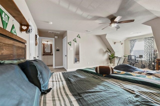 bedroom with ensuite bathroom, ceiling fan, and lofted ceiling