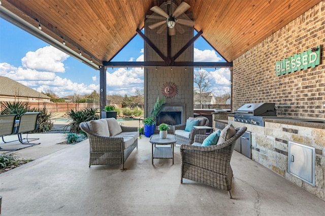 view of patio / terrace with an outdoor living space with a fireplace, grilling area, and an outdoor kitchen