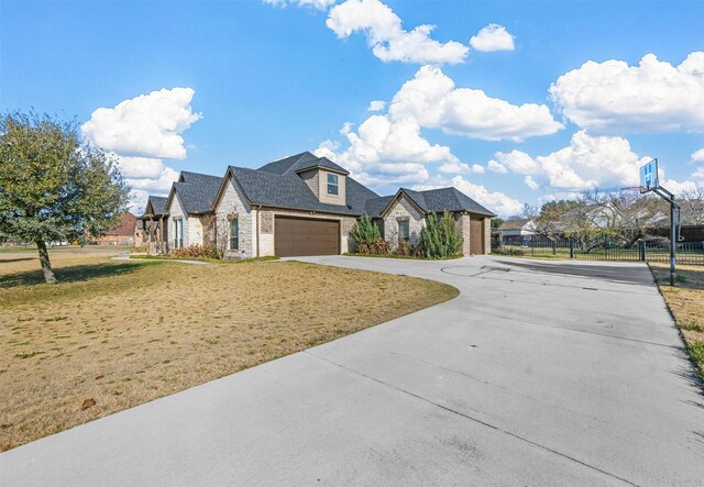 view of front of home featuring a garage and a front lawn