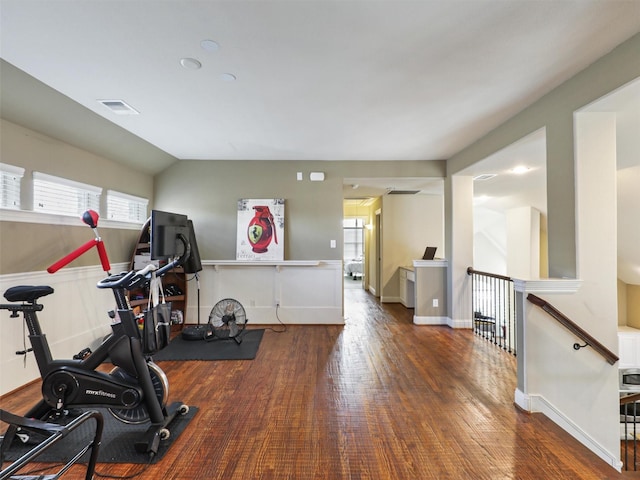 exercise area with dark hardwood / wood-style flooring and lofted ceiling