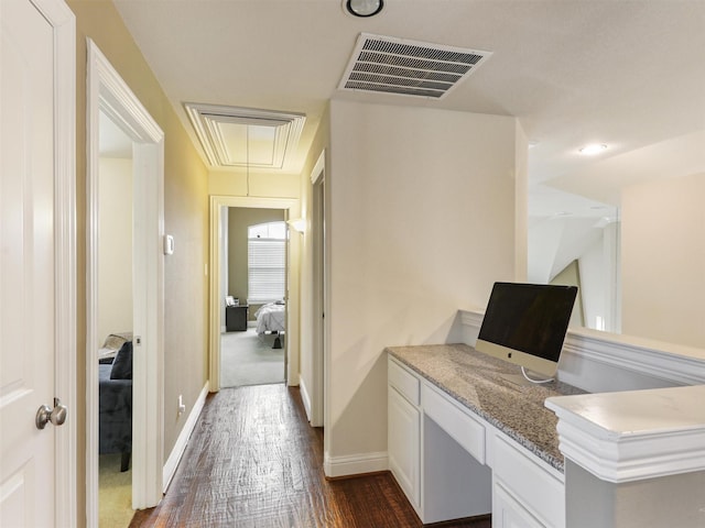 office area featuring dark hardwood / wood-style floors and built in desk