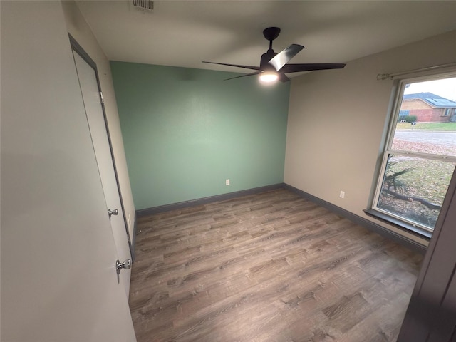 empty room featuring ceiling fan and wood-type flooring