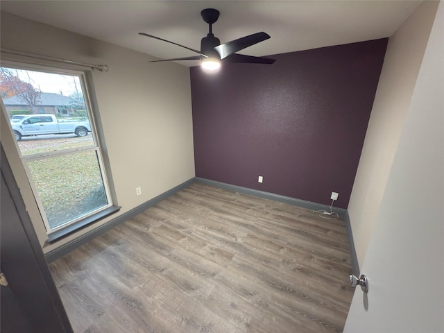 spare room featuring light hardwood / wood-style floors and ceiling fan