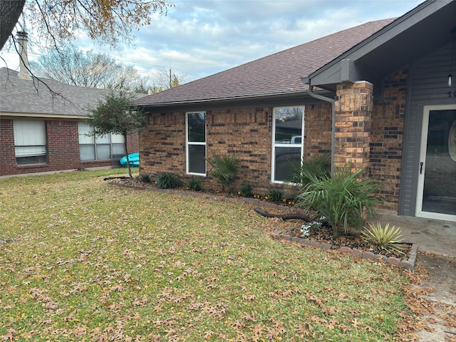 view of side of home featuring a lawn