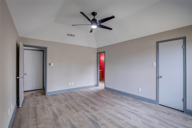 unfurnished room with ceiling fan, vaulted ceiling, and light hardwood / wood-style flooring