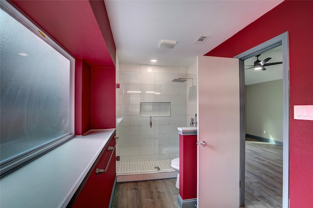 bathroom with toilet, hardwood / wood-style floors, vanity, and walk in shower