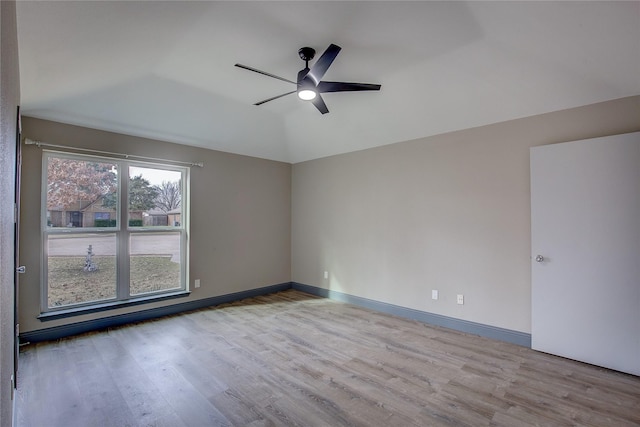 spare room featuring lofted ceiling, ceiling fan, and light hardwood / wood-style flooring