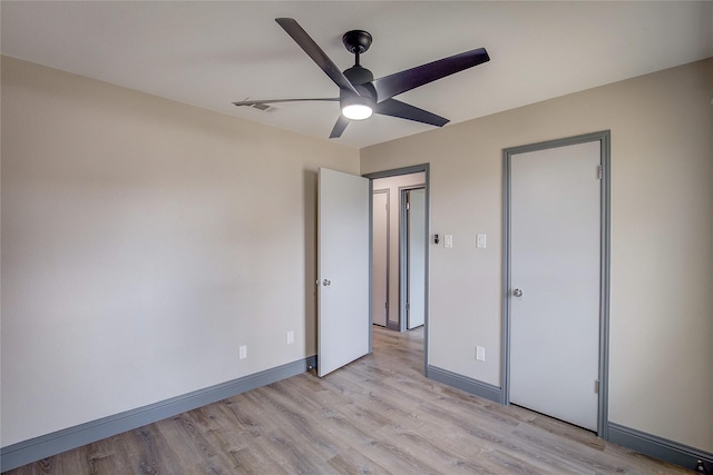 unfurnished bedroom featuring ceiling fan and light wood-type flooring