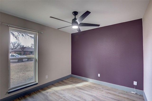 unfurnished room featuring ceiling fan and light hardwood / wood-style flooring