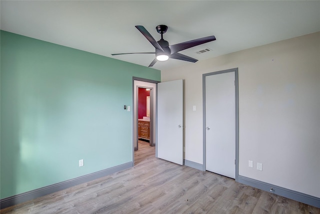 unfurnished bedroom with ceiling fan, light wood-type flooring, and a closet