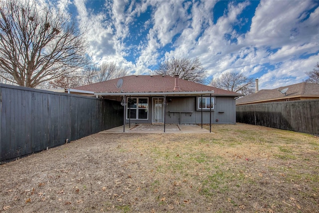 rear view of house with a patio area and a lawn