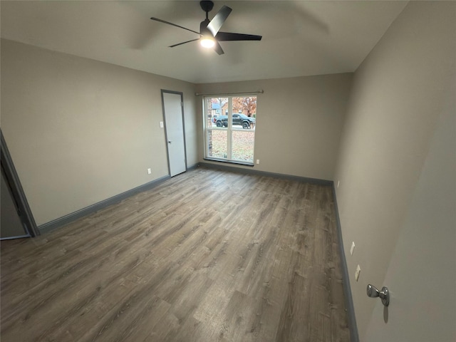 unfurnished room with ceiling fan and hardwood / wood-style floors