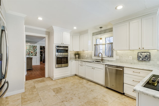 kitchen with light stone countertops, white cabinetry, sink, and stainless steel appliances