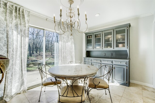 tiled dining room featuring crown molding and a notable chandelier