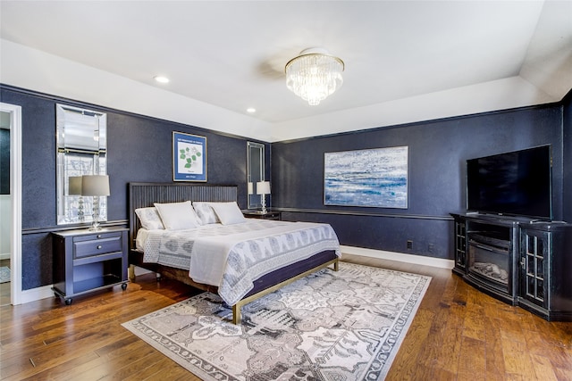 bedroom featuring dark wood-type flooring and a notable chandelier