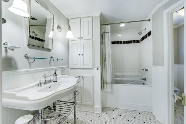 full bathroom featuring sink, tile patterned floors, crown molding, toilet, and shower / bath combo with shower curtain