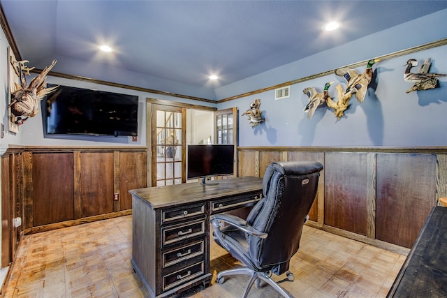 office area with light parquet floors and wood walls