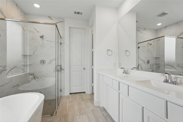 1829 Dolce Ln, Mclendon Chisholm, TX 75032 - bathroom featuring a marble finish shower, visible vents, a freestanding tub, and a sink