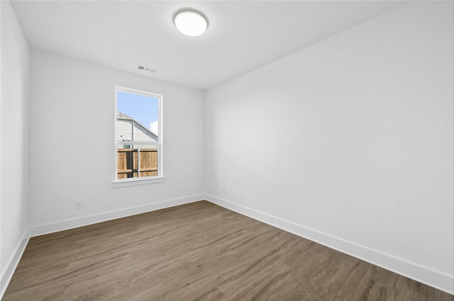 empty room with dark wood-type flooring