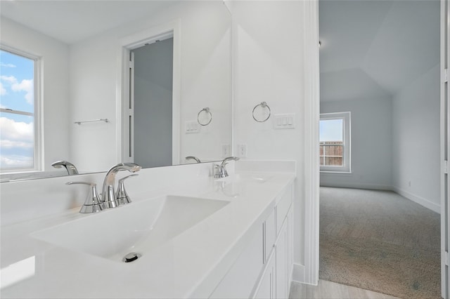 1829 Dolce Ln, Mclendon Chisholm, TX 75032 - bathroom with baseboards, double vanity, vaulted ceiling, and a sink