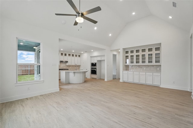 1829 Dolce Ln, Mclendon Chisholm, TX 75032 - unfurnished living room featuring baseboards, a ceiling fan, visible vents, high vaulted ceiling, and light wood finished floors