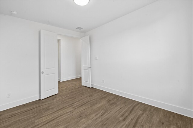 unfurnished bedroom with dark wood-type flooring