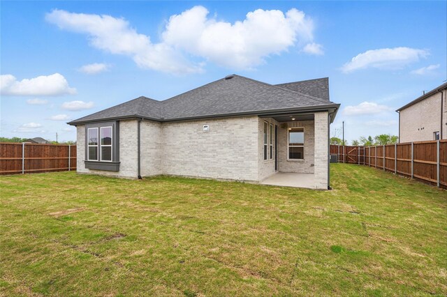 1829 Dolce Ln, Mclendon Chisholm, TX 75032 - rear view of house with a patio area, brick siding, a fenced backyard, a yard, and a shingled roof