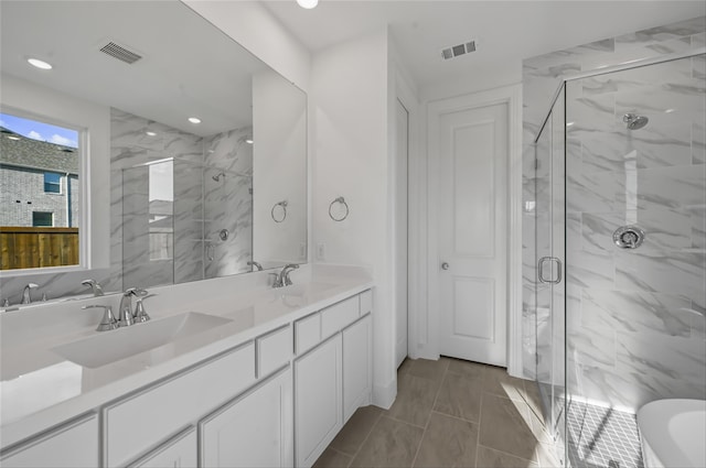 bathroom with vanity and a shower with shower door