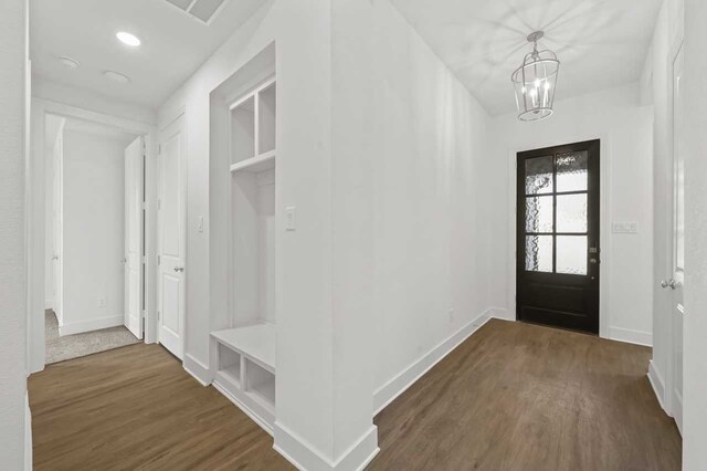 entryway with a chandelier and dark hardwood / wood-style flooring