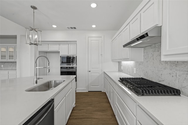 kitchen with white cabinetry, appliances with stainless steel finishes, sink, and pendant lighting