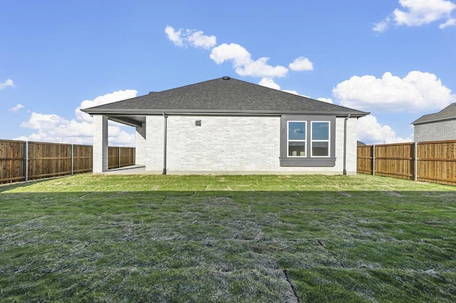 rear view of property with a lawn