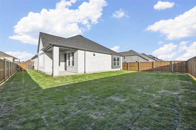 back of house with a yard, cooling unit, and a patio area