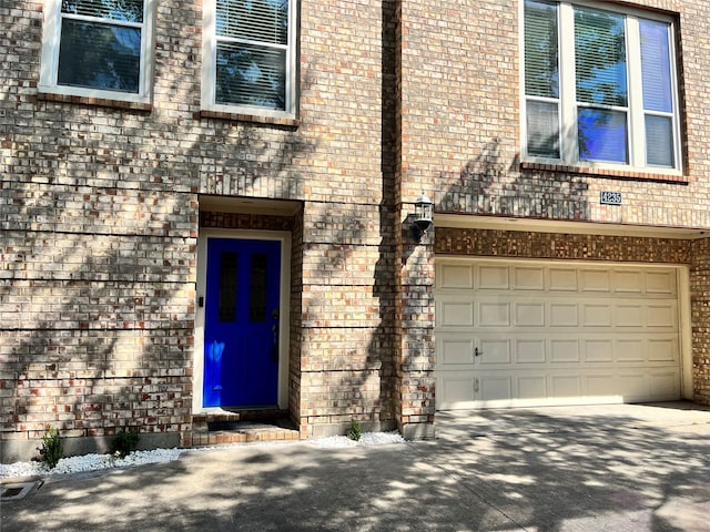 doorway to property featuring a garage