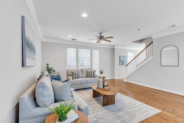 living room with ceiling fan, light hardwood / wood-style floors, and ornamental molding