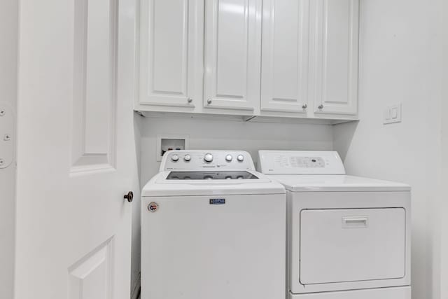 washroom featuring cabinets and separate washer and dryer