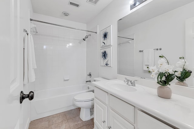 full bathroom with tile patterned floors, vanity, tiled shower / bath combo, and toilet