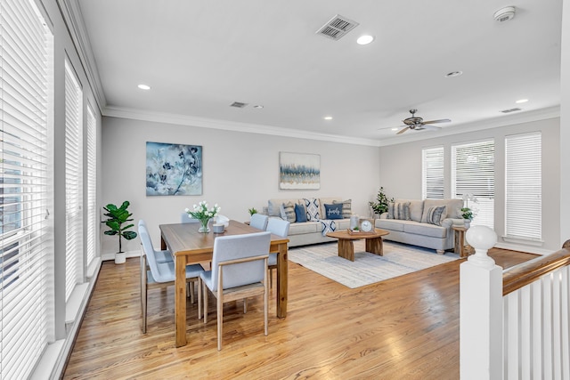 dining room with ceiling fan, light hardwood / wood-style flooring, and crown molding