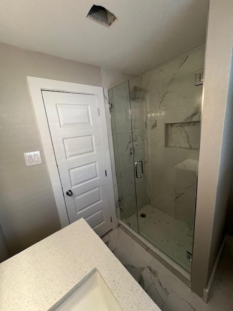 bathroom with vanity and walk in shower