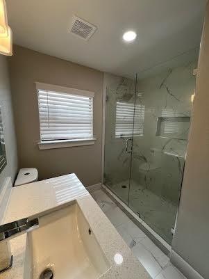 bathroom featuring a shower with shower door