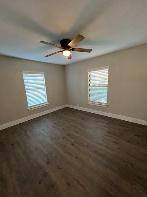 spare room with dark hardwood / wood-style floors and ceiling fan