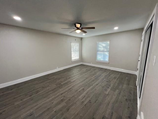 unfurnished bedroom with ceiling fan and dark wood-type flooring