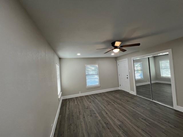 spare room with dark hardwood / wood-style floors and ceiling fan