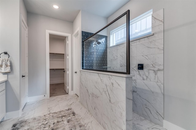 bathroom with vanity and tiled shower